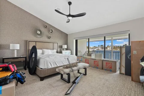 a bedroom with furniture and a large window