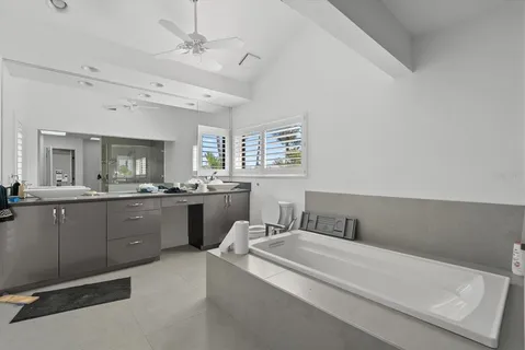 a bathroom with a sink double vanity granite and a mirror