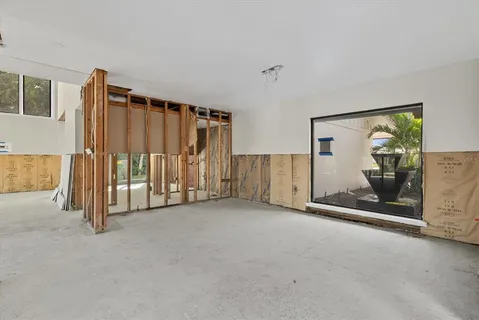 a view of a livingroom with wooden floor and stairs