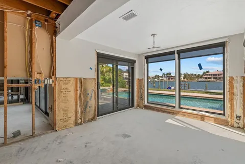 a view of a room with an empty space and windows