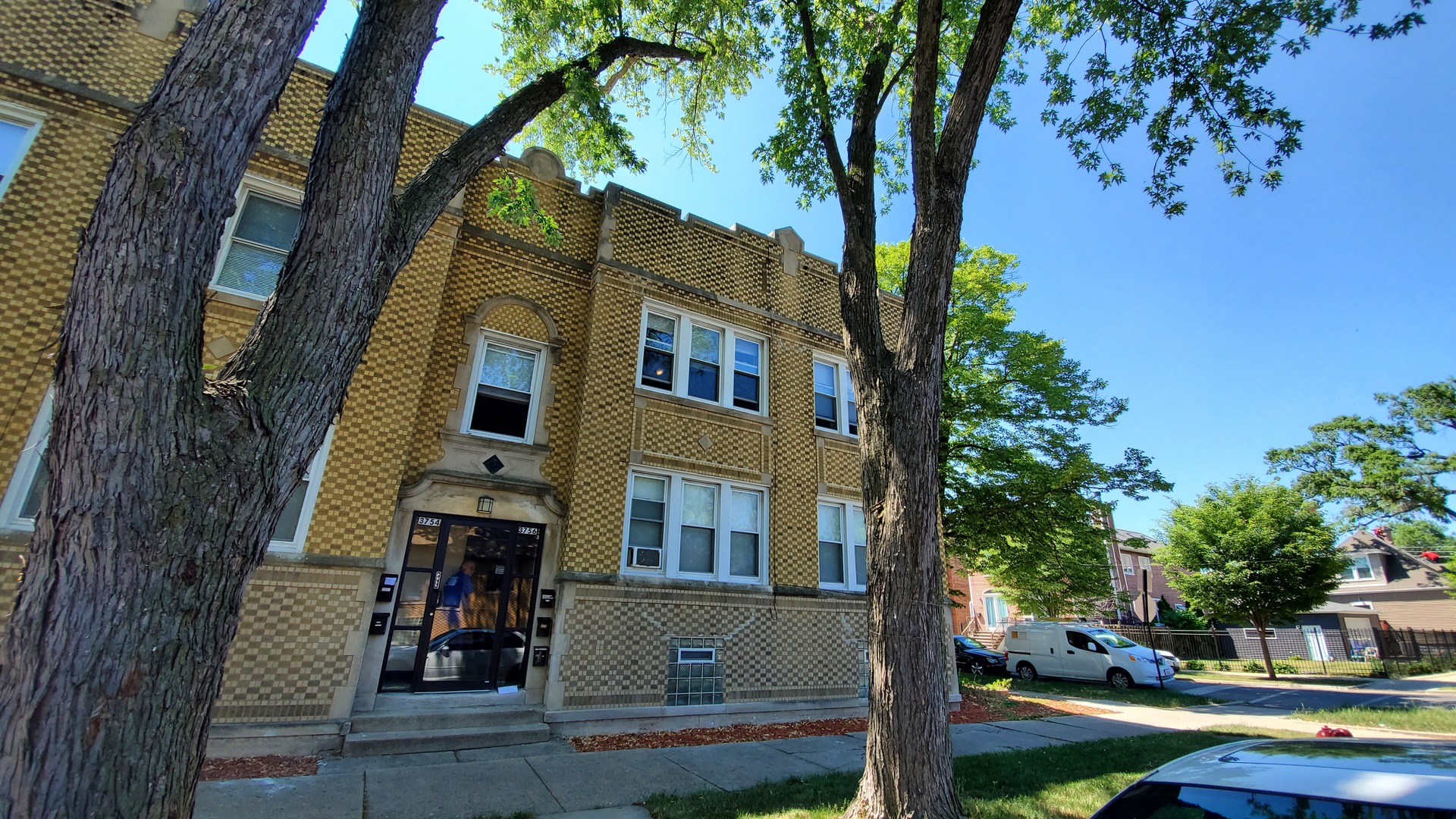 a front view of a house with tree s