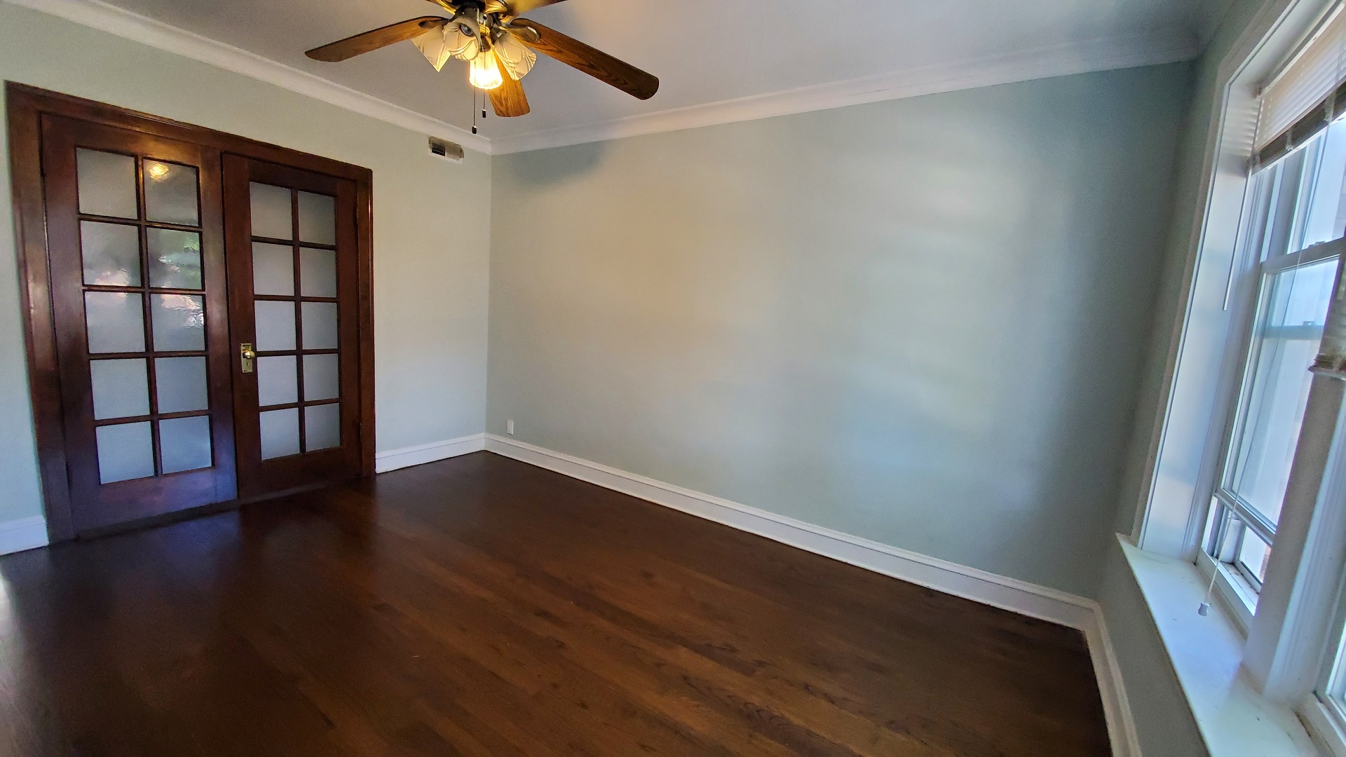 3756 North Kilpatrick Avenue, Unit 2 Chicago, IL 60641 - Photo 3 of 6 wooden floor in an empty room with a window