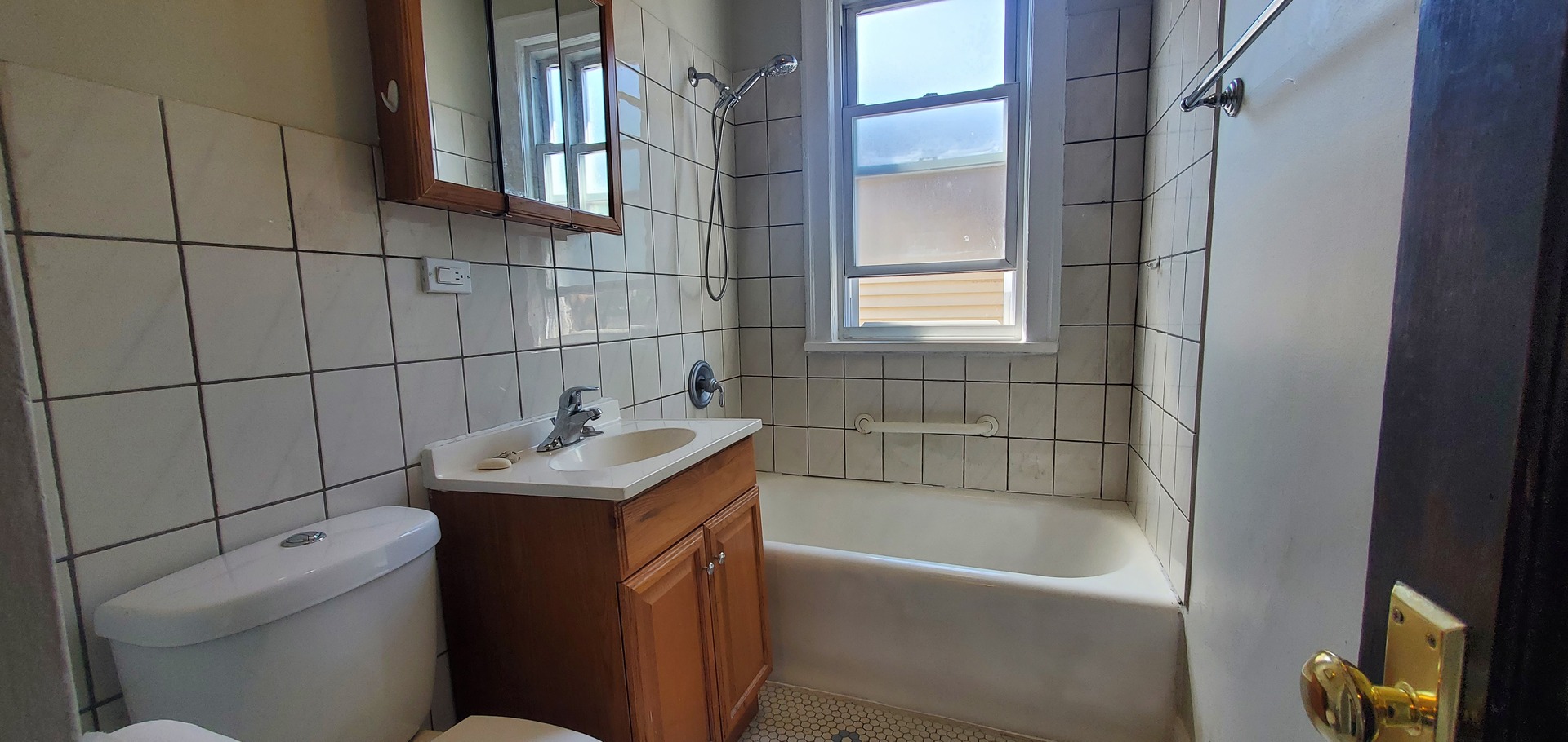 3756 North Kilpatrick Avenue, Unit 2 Chicago, IL 60641 - Photo 4 of 6 a bathroom with a sink toilet vanity and bathtub