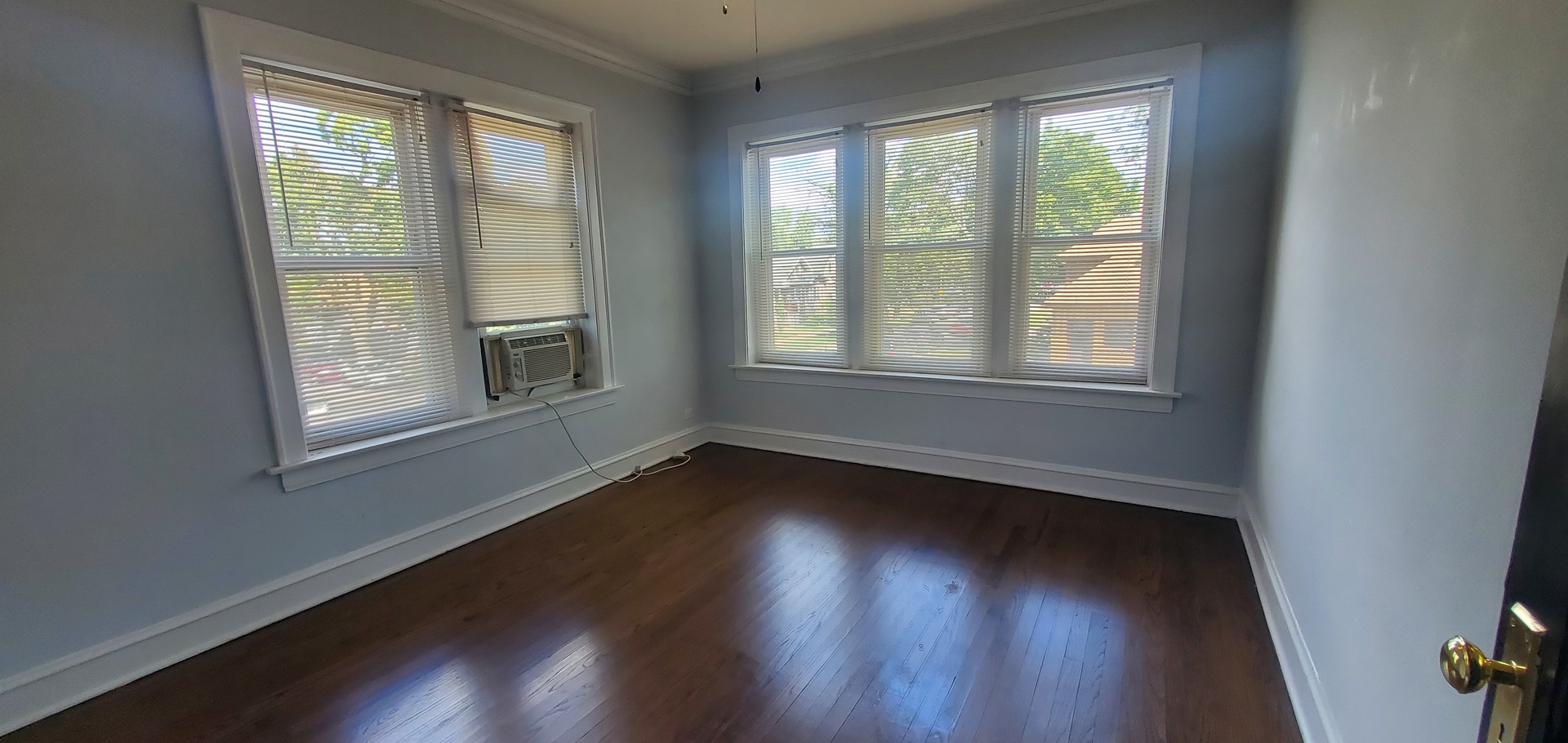 3756 North Kilpatrick Avenue, Unit 2 Chicago, IL 60641 - Photo 6 of 6 a view of an empty room with wooden floor and a window
