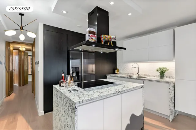 a kitchen with stainless steel appliances granite countertop a sink and a refrigerator