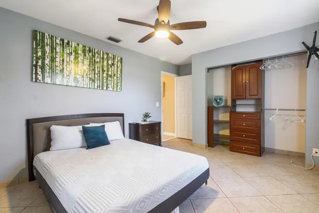 a bedroom with a bed and a chandelier