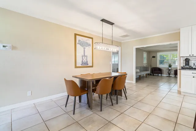 a dining room with furniture and chandelier
