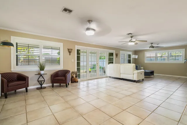 a living room with furniture and large windows