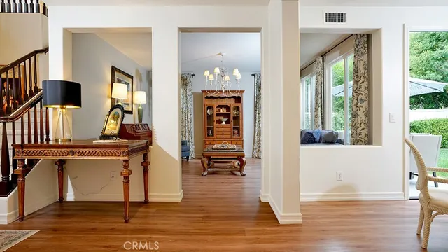 a view of swimming pool with lawn chairs under an umbrella