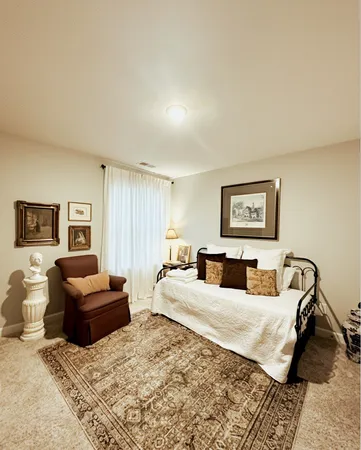 a bedroom with a bed and a couch
