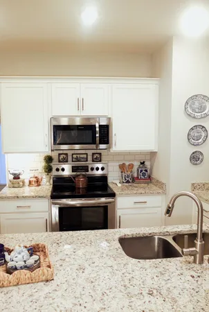 a kitchen with a stove a sink and a microwave