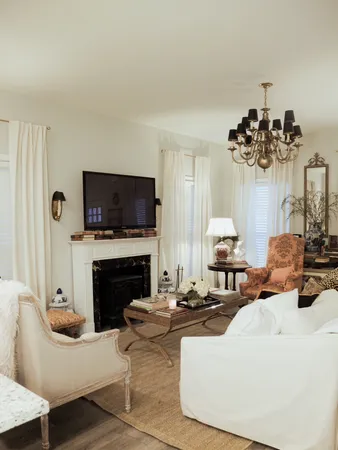 a living room with furniture a fireplace and a flat screen tv