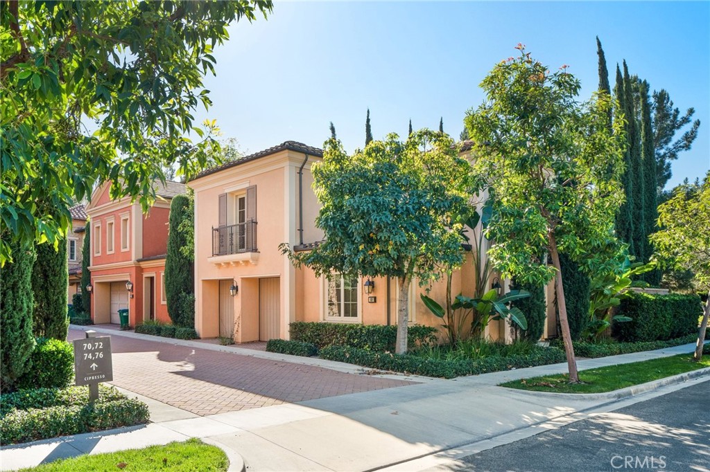 a front view of a house with a yard and trees