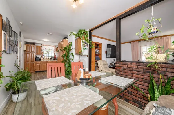 a living room with fireplace furniture and a potted plant