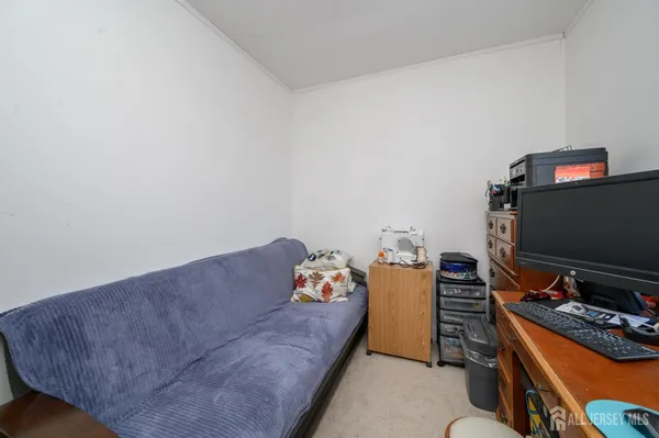 a bedroom with furniture and a flat screen tv