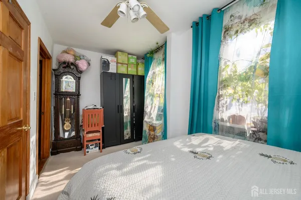 a bedroom with a bed next to a window