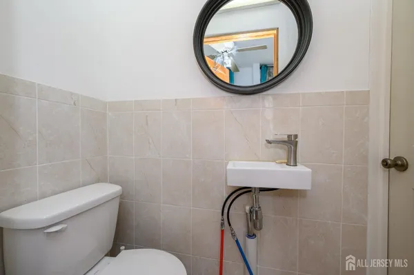 a bathroom with a toilet and a mirror