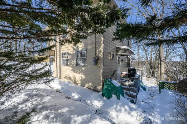 a view of a chairs and table in the backyard