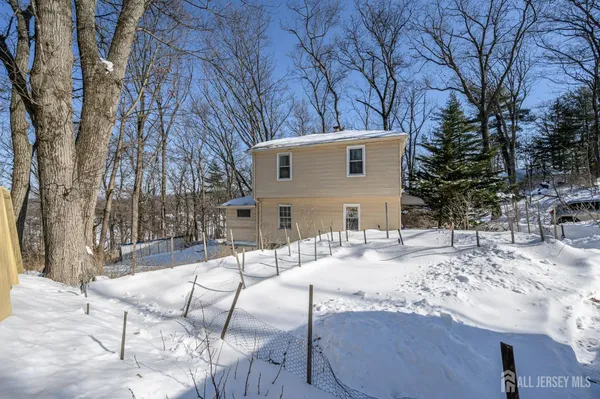 a view of house with yard and covered with snow