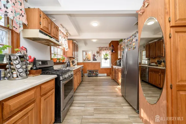 a kitchen with stainless steel appliances granite countertop a refrigerator and a sink