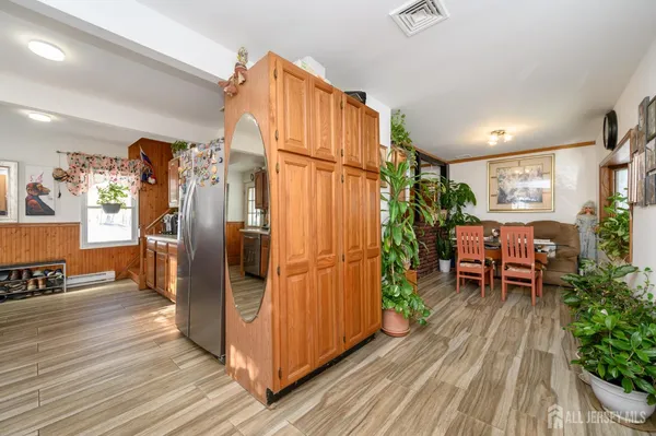 a view of living room kitchen with furniture and wooden floor
