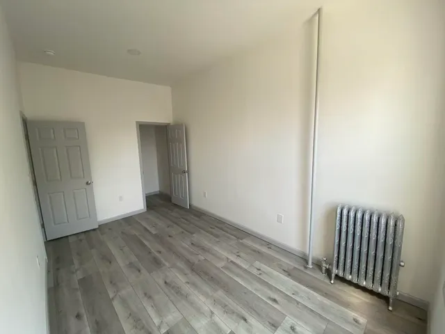 a view of a livingroom with wooden floor and door