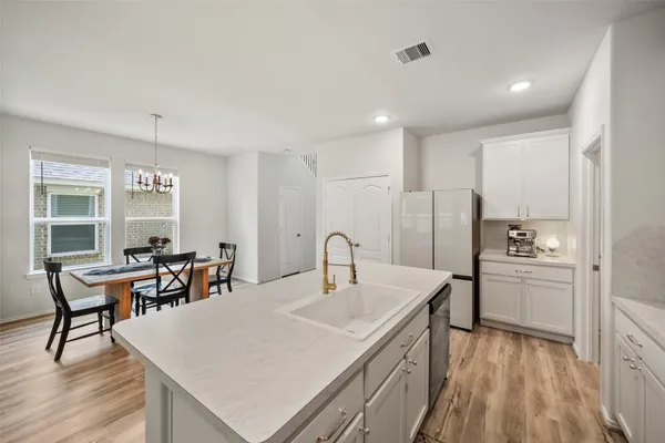 a en suite bathroom with a double vanity sink a mirror and a shower