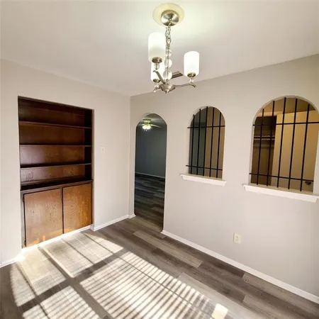 a bedroom with bed and wooden floor