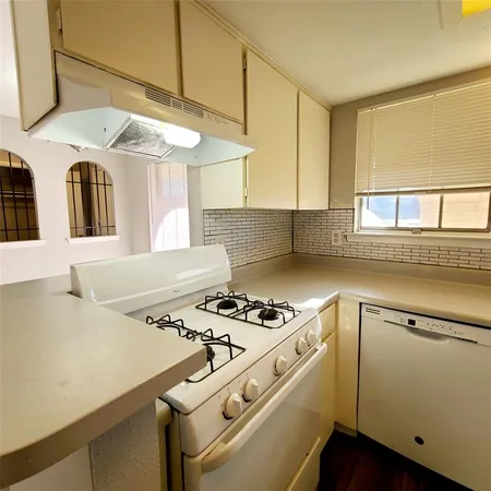a kitchen with a stove cabinets and a refrigerator
