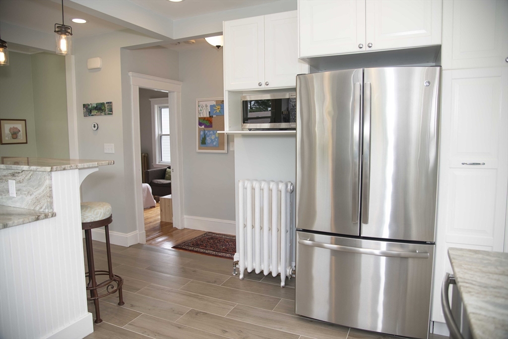 3 Chester Road, Unit 3 Belmont, MA 02478 - Photo 7 of 40 a kitchen with stainless steel appliances a refrigerator and wooden floor