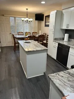 a kitchen with granite countertop a sink stove and refrigerator