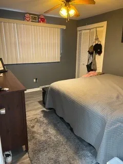 a bedroom with a bed and a painting on the wall