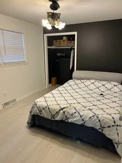 a bedroom with a bed and a ceiling fan