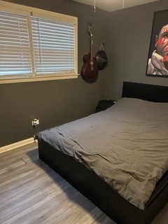 7733 Rutherford Avenue Burbank, IL 60459 - Photo 7 of 13 a bedroom with a bed and a window