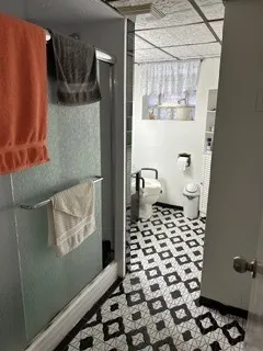 a bathroom with a toilet and a shower