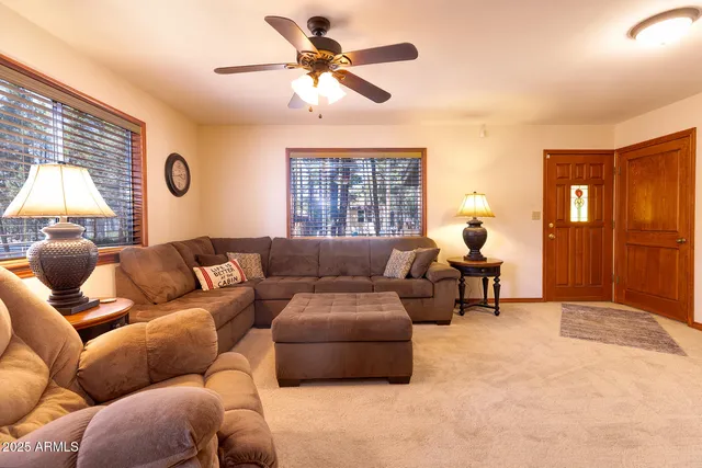 a living room with furniture a window and a chandelier