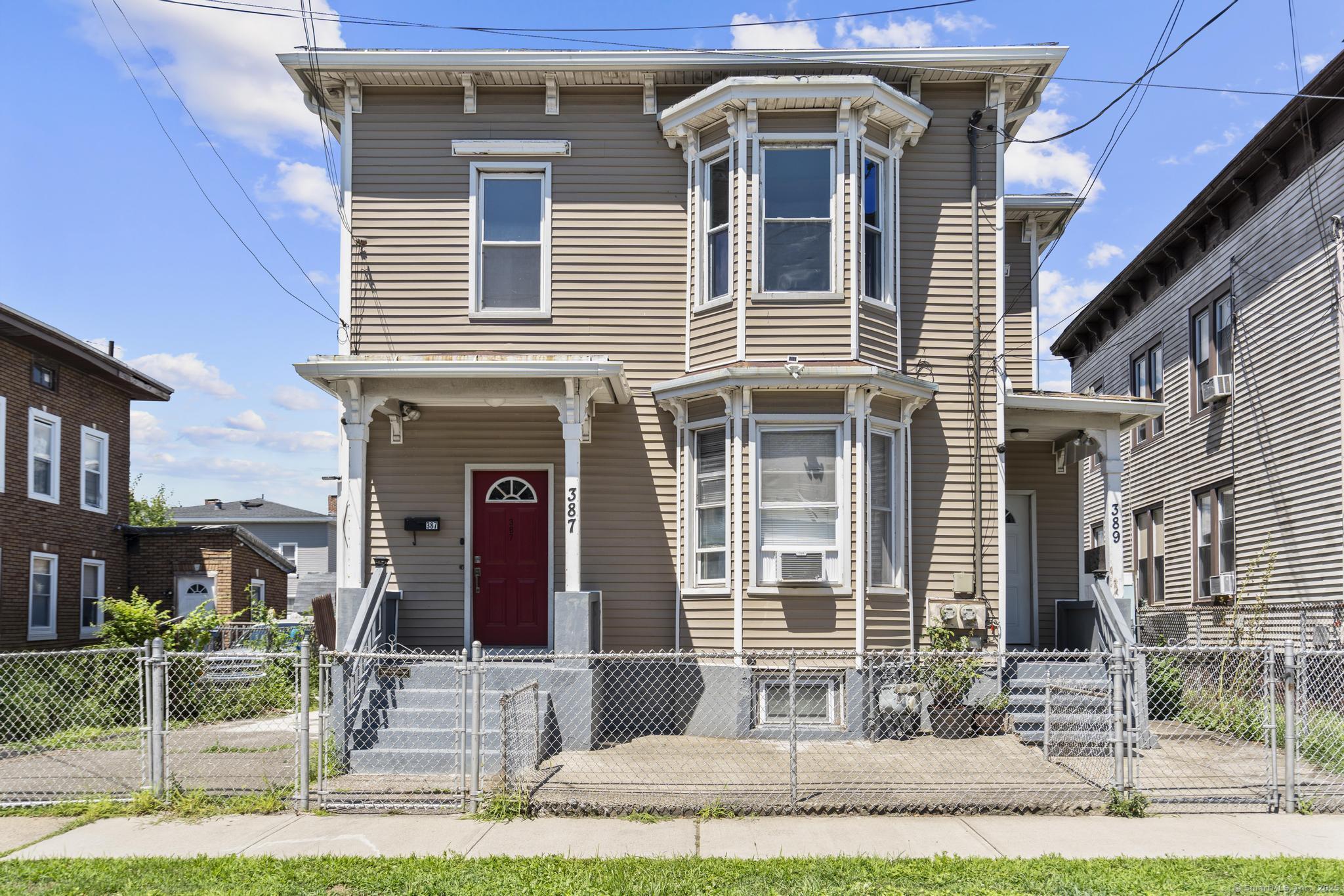 387 Nichols Street, Unit 2 Bridgeport, CT 06608 - Photo 1 of 28 a front view of a house with a yard
