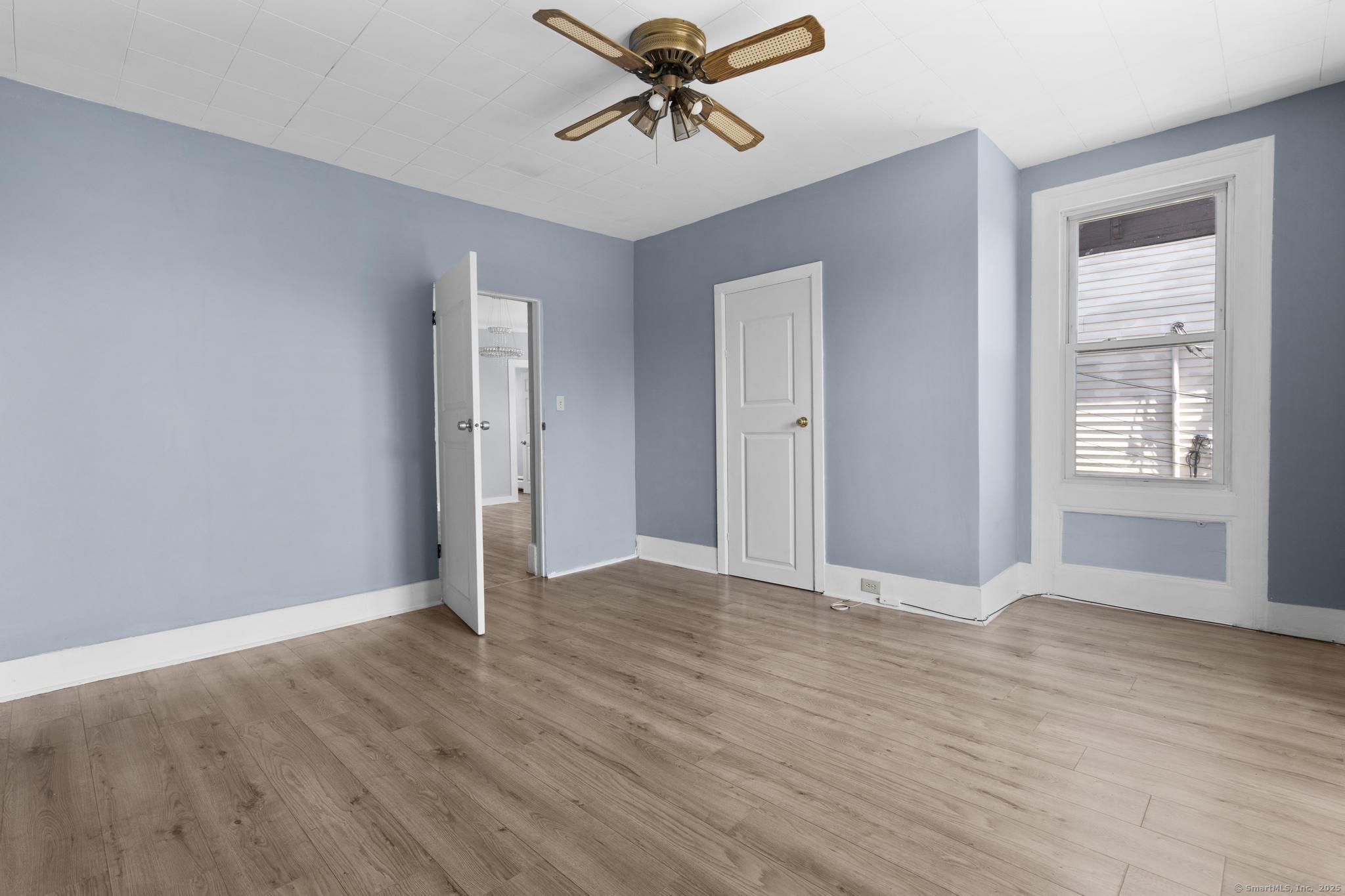 387 Nichols Street, Unit 2 Bridgeport, CT 06608 - Photo 11 of 28 a view of a livingroom with a chandelier fan and windows