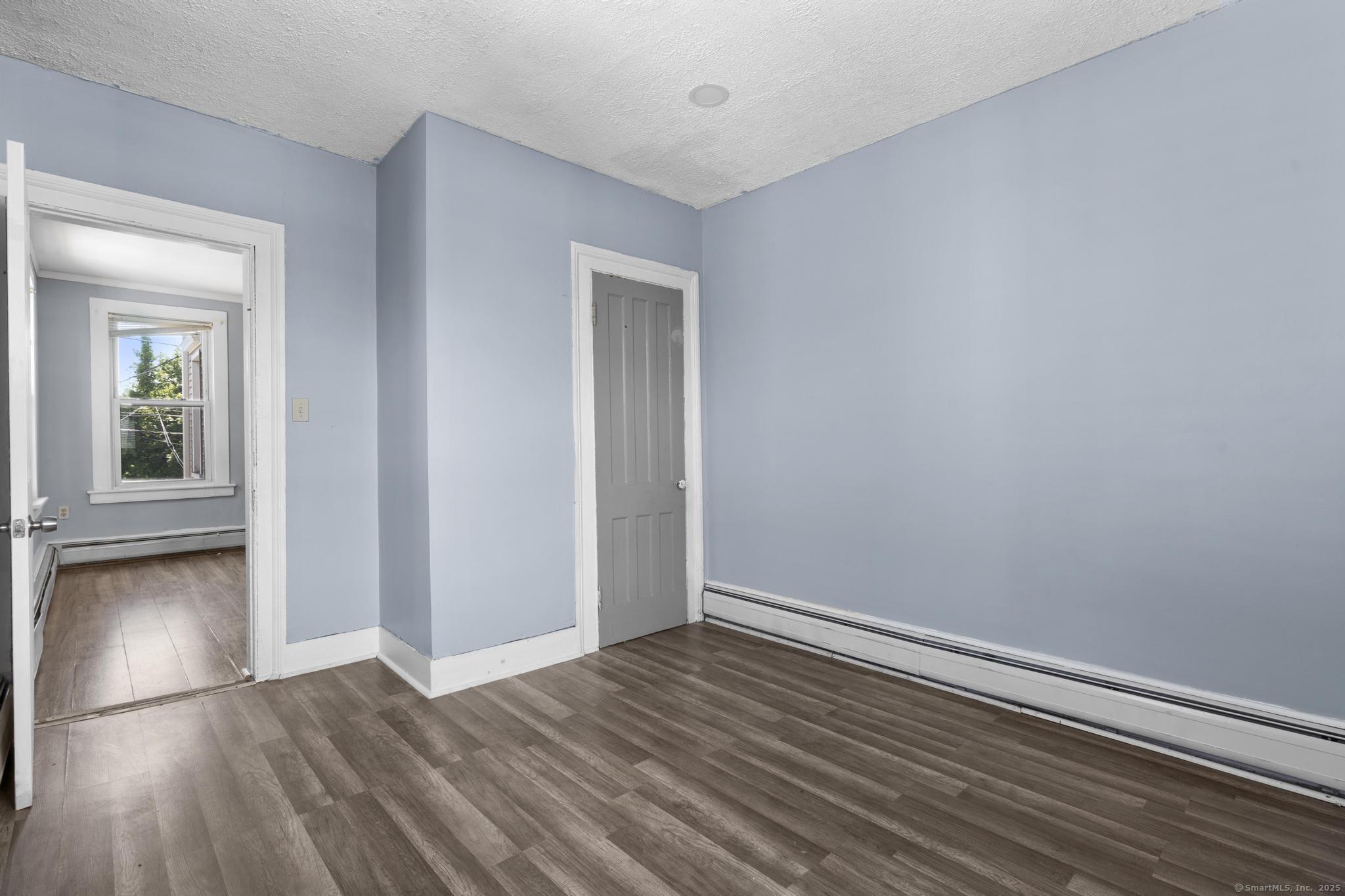 387 Nichols Street, Unit 2 Bridgeport, CT 06608 - Photo 15 of 28 a view of a room with wooden floor and window