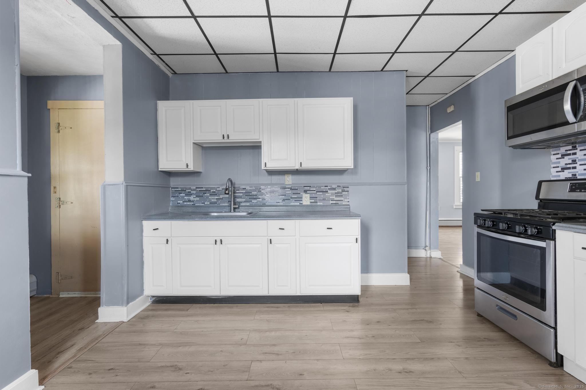 387 Nichols Street, Unit 2 Bridgeport, CT 06608 - Photo 23 of 28 a kitchen with stainless steel appliances granite countertop a stove a sink and a refrigerator