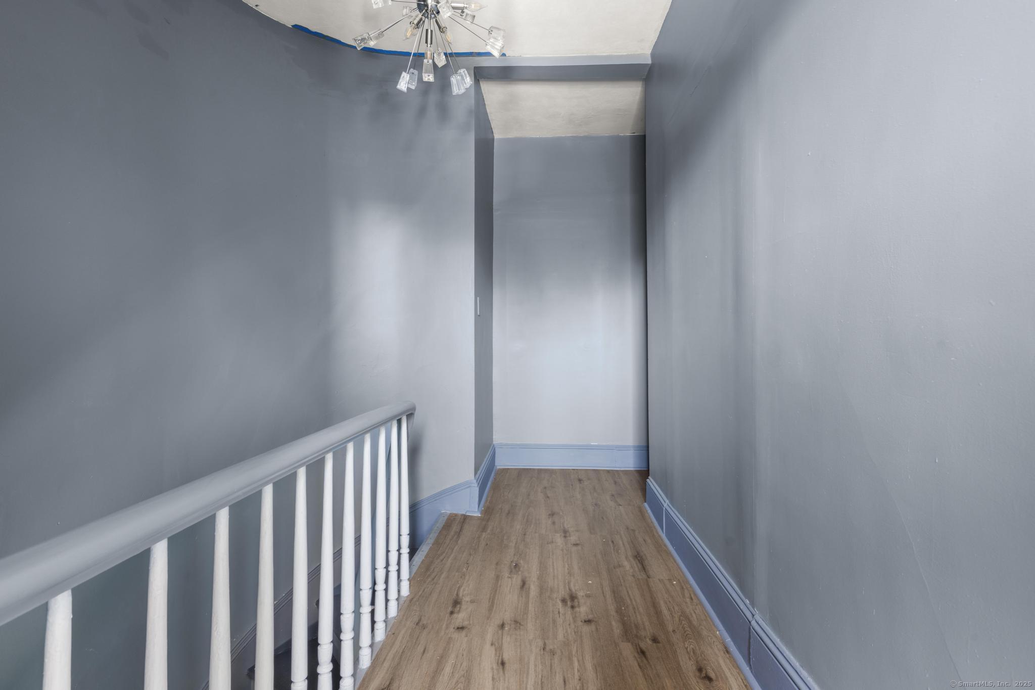 387 Nichols Street, Unit 2 Bridgeport, CT 06608 - Photo 3 of 28 a view of a hallway with wooden floor