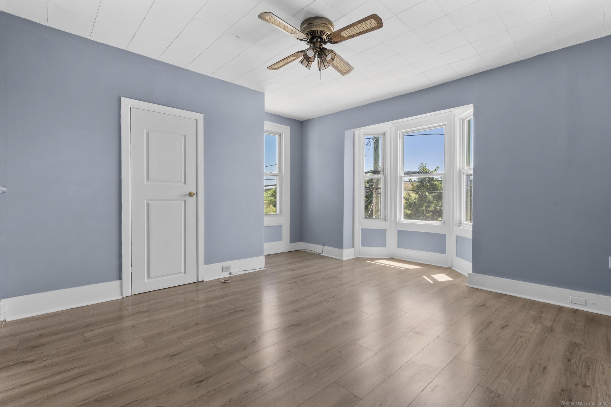387 Nichols Street, Unit 2 Bridgeport, CT 06608 - Photo 9 of 28 wooden floor in an empty room with a window