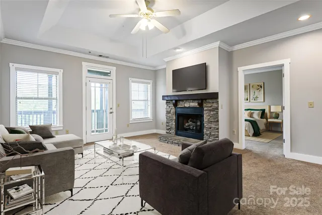 a living room with furniture a flat screen tv and a fireplace