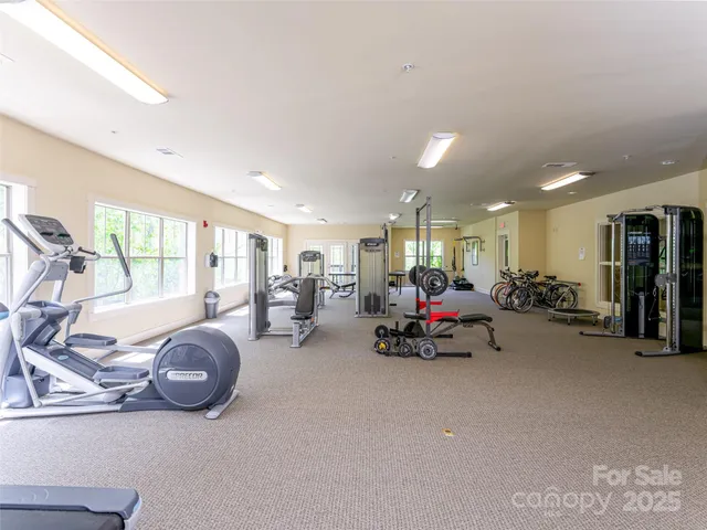 a living room with furniture a large window and dining table