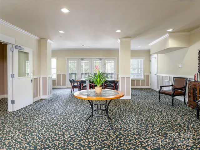 a view of a swimming pool with a lounge chair and the back yard