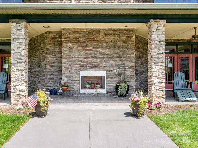 a view of a patio with table and chairs and potted plants