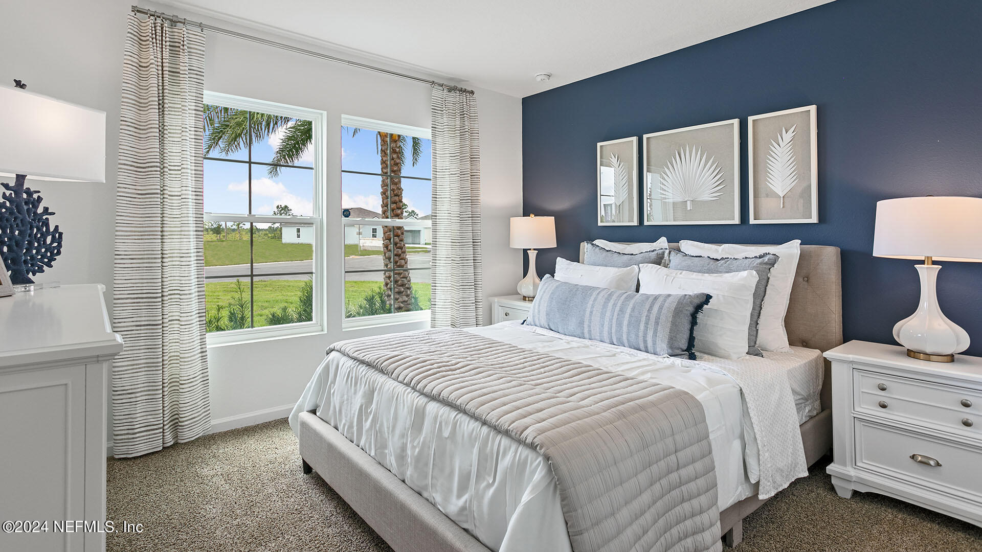 123 Hulett Wds Road Palm Coast, FL 32137 - Photo 16 of 33 a large bed sitting in a bedroom next to a window