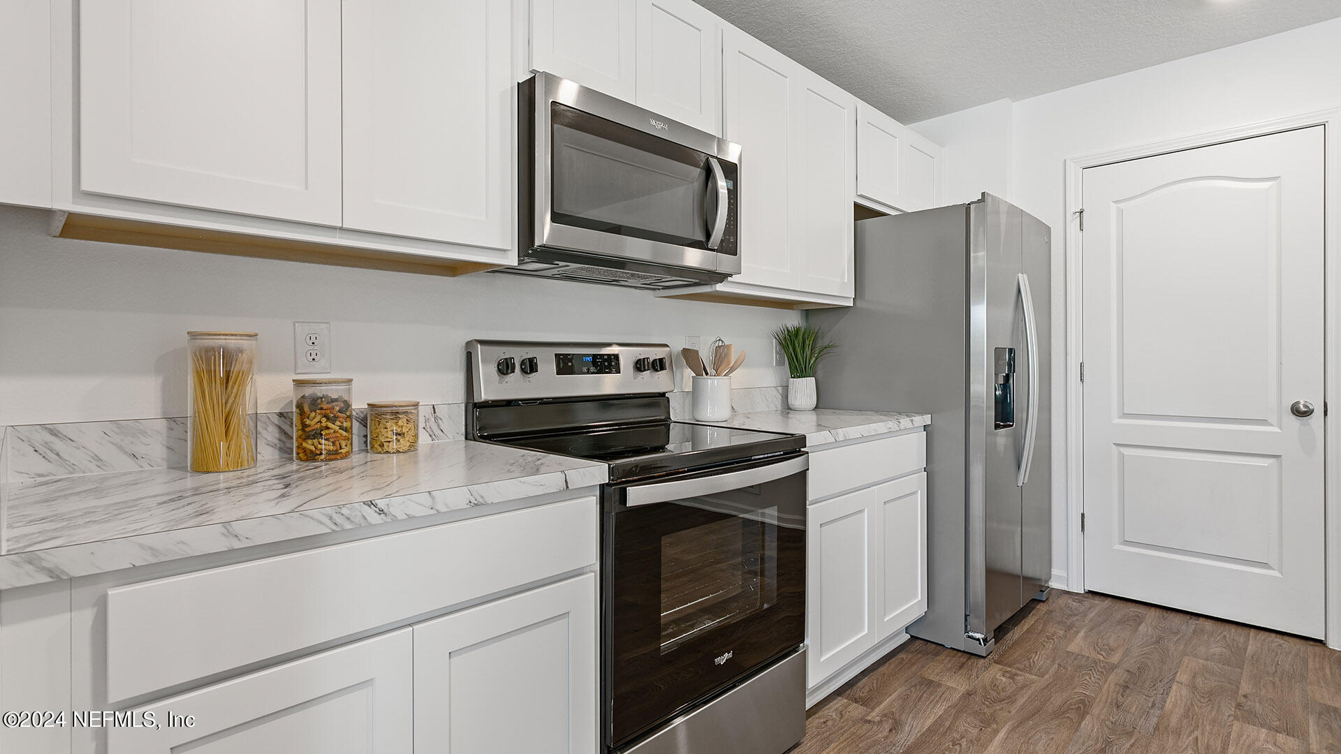 123 Hulett Wds Road Palm Coast, FL 32137 - Photo 5 of 33 a kitchen with stainless steel appliances granite countertop a refrigerator stove and sink