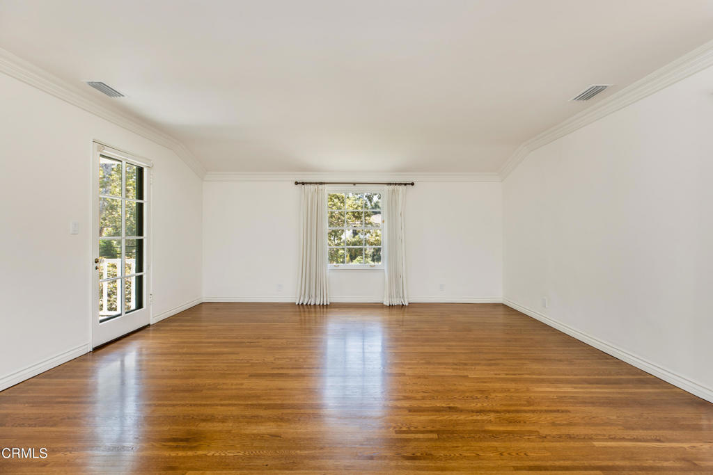1184 Arden Road Pasadena, CA 91106 - Photo 26 of 62 a view of an empty room with window and wooden floor