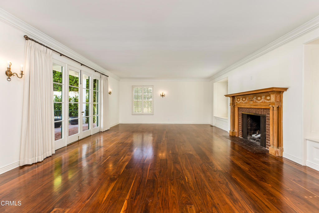 1184 Arden Road Pasadena, CA 91106 - Photo 6 of 62 a view of empty room with wooden floor and fireplace